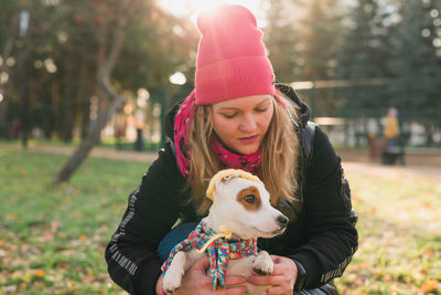 Portrait of young woman with dog