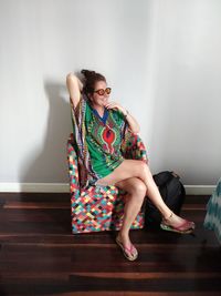 Young woman sitting on sofa at home