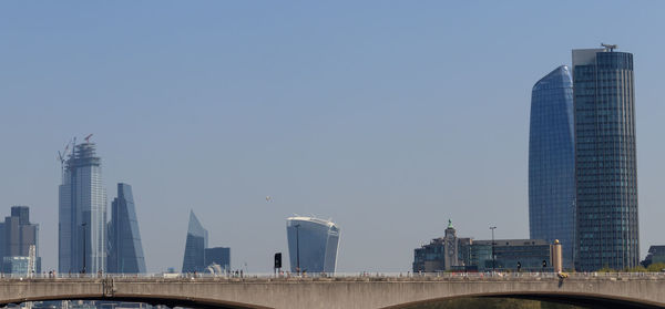 Modern buildings in city against clear sky