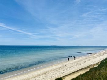 Scenic view of beach against blue sky