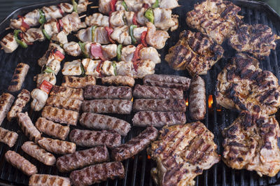 High angle view of meat on barbecue grill