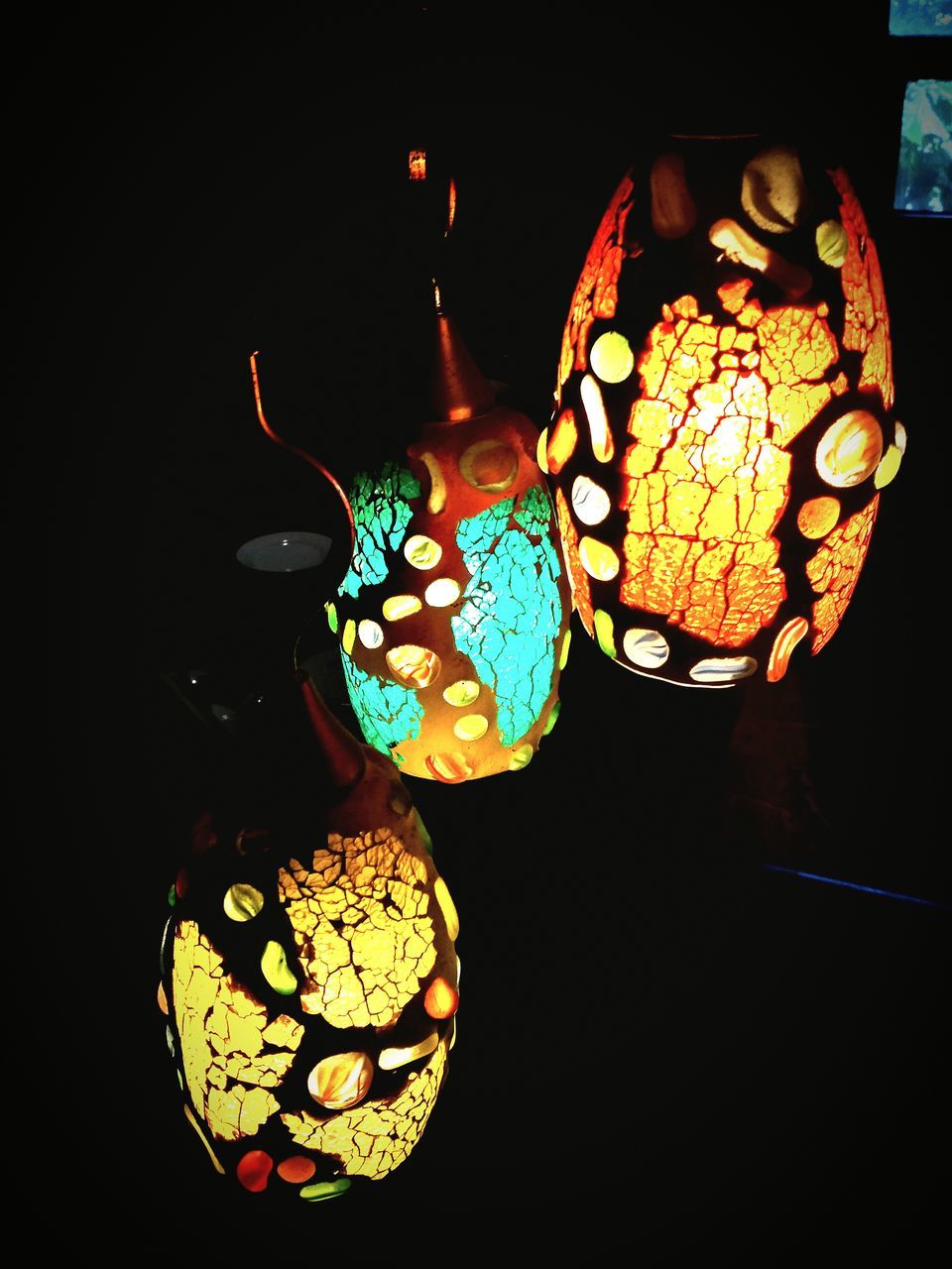 LOW ANGLE VIEW OF ILLUMINATED LANTERNS HANGING ON WALL