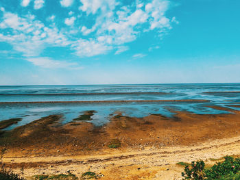 Scenic view of sea against blue sky