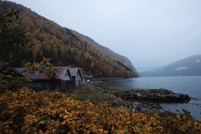 Scenic view of lake by mountain against sky