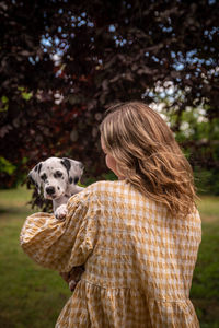 Young woman with a dalmatian puppy