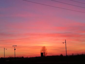 Low angle view of silhouette trees against sky at sunset