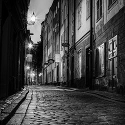 Street amidst buildings at night