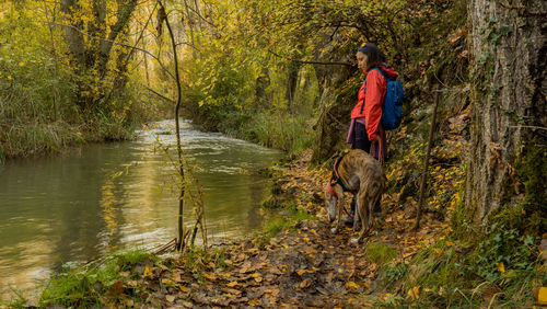 Rear view of woman standing in forest