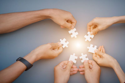 Close-up of hands holding puzzle pieces