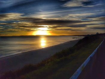 Scenic view of beach against sky during sunset