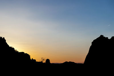 Silhouette landscape against sky during sunset