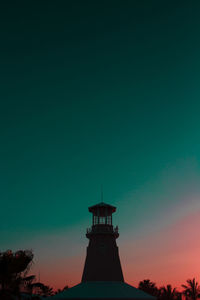 Low angle view of lighthouse against sky during sunset