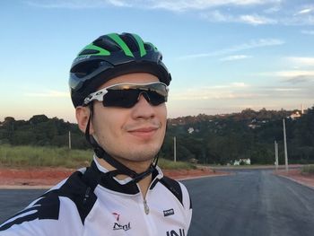 Portrait of young man wearing sunglasses against sky on sunny day