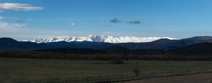 Scenic view of landscape and mountains against sky