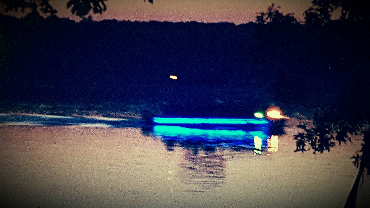 water, illuminated, transportation, beach, night, sea, mode of transport, shore, reflection, sand, multi colored, outdoors, tranquility, tree, nature, boat, tranquil scene, copy space, nautical vessel, motion