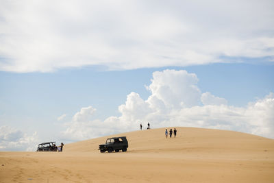 Scenic view of sand dunes against sky