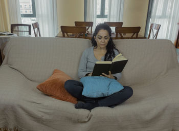 Man using mobile phone while sitting at home