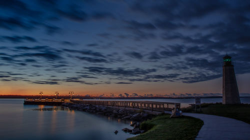 Bridge over river against cloudy sky