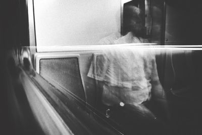 Reflection of man on train window