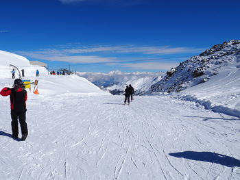 Tourists on snow covered mountain