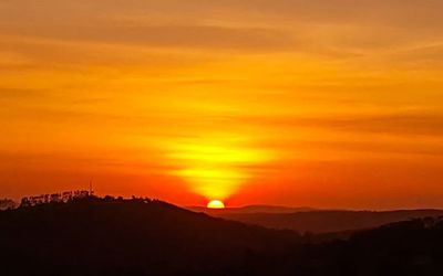 Scenic view of mountains against sky at sunset