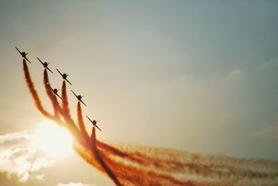 Low angle view of airplane flying against sky