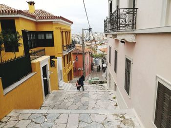 Rear view of man walking on houses