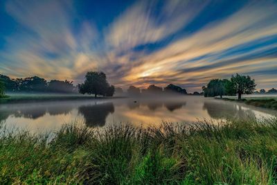 Scenic view of lake against sky during sunset