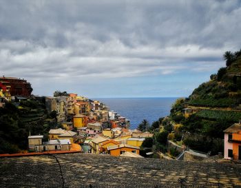 High angle view of townscape by sea against sky