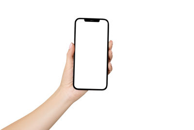 Cropped hand of woman using smart phone against white background