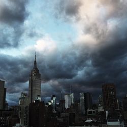 Skyscrapers against cloudy sky