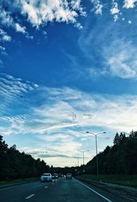 Cars on road against sky