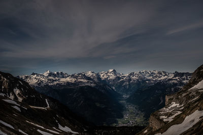 Scenic view of snowcapped mountains against sky during winter