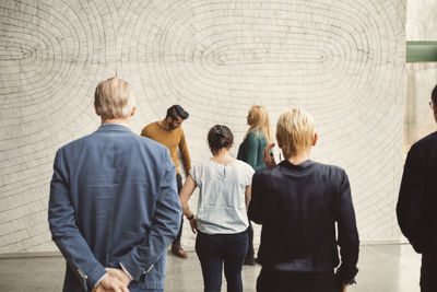 Rear view of multi-ethnic business people in creative office