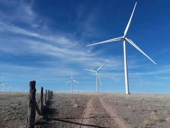 Windmill on field against sky