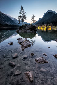 Scenic view of lake against sky at sunset