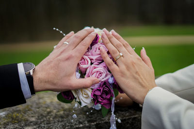 Midsection of couple holding hands