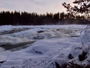 Scenic view of frozen lake against sky during sunset