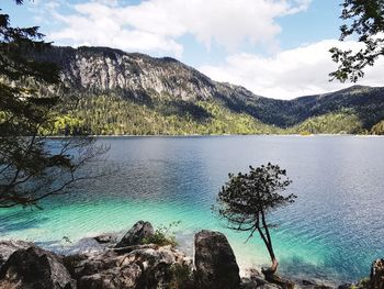 Scenic view of lake and mountains against sky