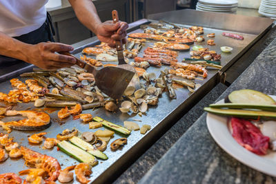 Midsection of person preparing food on table