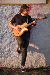 Street musician playing electric guitar in the street