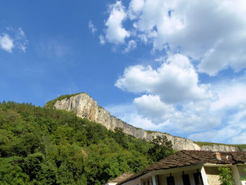 Low angle view of building against cloudy sky