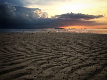 Scenic view of beach against sky during sunset