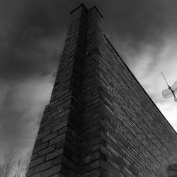 Low angle view of building against cloudy sky