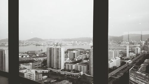 Cityscape against sky seen through window