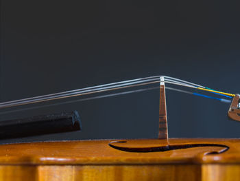 Close-up of metallic structure on table against black background