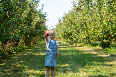 Full length of a girl standing by tree