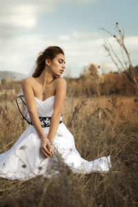 Young woman sitting on a field