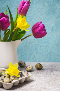 Close-up of multi colored tulips in vase on table