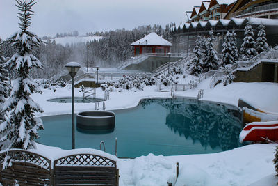 Houses by swimming pool during winter
